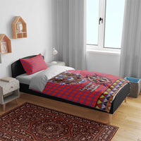 Red and blue plaid bedding set with Maasai beadwork face motif on duvet and pillowcases