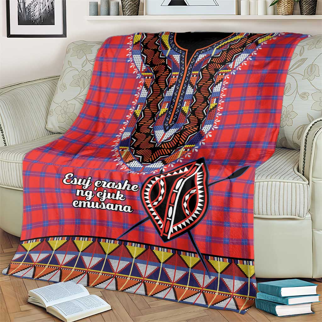 Red plaid shuka throw blanket with black-and-white embroidered face motif and patterned hem