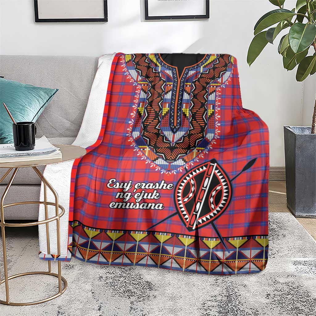 Red plaid shuka blanket draped on sofa, black-and-white motif with colorful geometric border