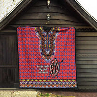 Masai shuka quilt hanging up: red-blue plaid with black dashiki V-neck beadwork and trim