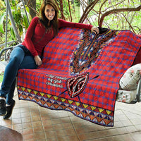 Masai shuka quilt draped on seating: red-blue plaid, black dashiki beaded V panel