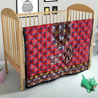 Masai shuka quilt in crib: red-blue plaid with black dashiki V panel and geometric border