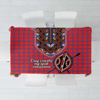 Red and blue plaid tablecloth with black-and-white tribal dashiki beadwork centerpiece