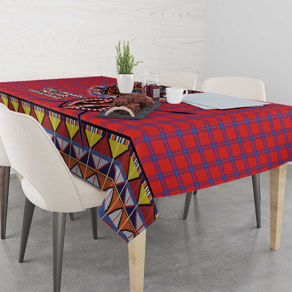 Red blue plaid tablecloth with multicolor geometric trim along table edge