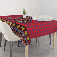 Red blue plaid tablecloth with multicolor geometric trim along table edge