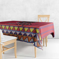 Red plaid tablecloth corner with multicolor zigzag and diamond band trim