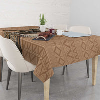 Brown tablecloth with repeating geometric diamond pattern and central wildlife illustration