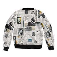 Newspaper-print bomber jacket with black ribbed hem, collar, and cuffs (collage back)