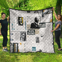 White newspaper-print style quilt spread outdoors with portrait photo collage
