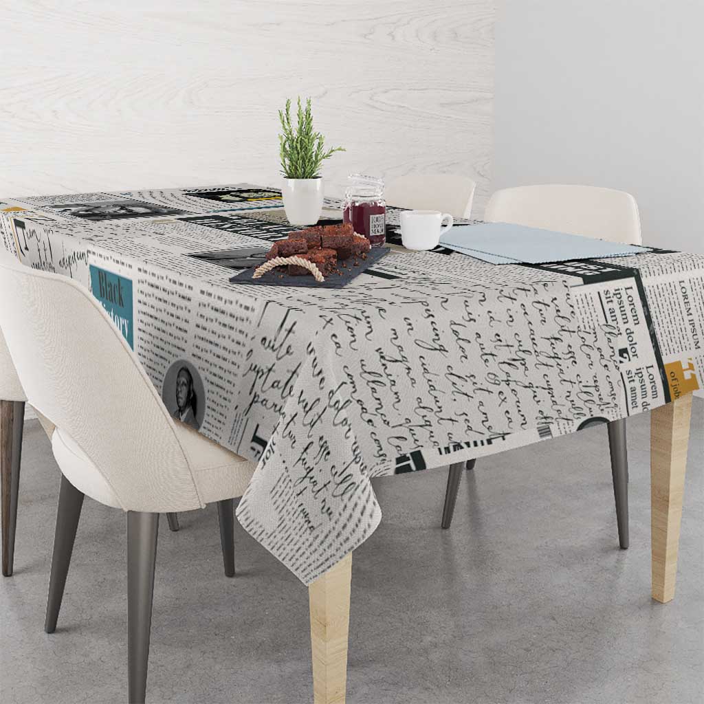 Newspaper print tablecloth with script text and photo figures, draped over tabletop