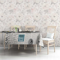 Newspaper print tablecloth on dining table with black-and-white text design and borders