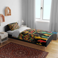 I AM Black bedding set on bed with gray base and colorful map-and-hands artwork.