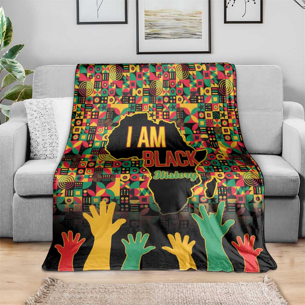 Black History Month blanket draped on sofa: bold “I AM BLACK” design with raised hands