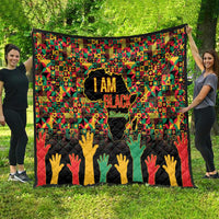 Colorful I Am Black quilt featuring black silhouette, raised hands at bottom, geometric pattern