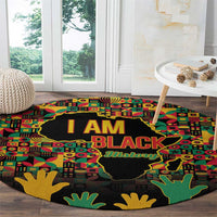Round decorative history rug, I AM BLACK text and African map, corner hands in green and yellow