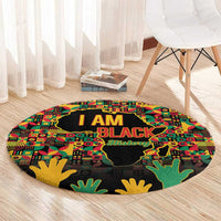 Round graphic history rug with African map silhouette and bold I AM BLACK text in multicolor