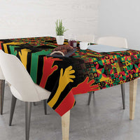 Rectangular tablecloth draped over dining table with black, red, green, and yellow graphics