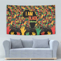 Black History Month tapestry showing “I AM BLACK” text over a globe and multicolor hand icons
