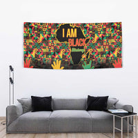 Vibrant wall tapestry with “I AM BLACK” wording, globe silhouette, and colorful raised hands