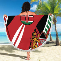 Round red, black, and white Simba flag blanket with white fringe, held open outdoors.