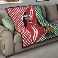 Kenya flag style quilt blanket on a sofa with red, white, green stripes and lion crest
