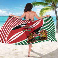 Red, green, and black rugby flag sarong showing full back print with crest