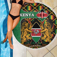 Round green Kenya beach blanket partially over pool, coat of arms shield, kente border, fringe