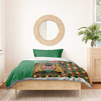 Green Kenya bedding set with coat of arms crest and kente zigzag trim, duvet and pillow.