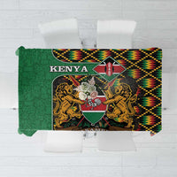 Green tablecloth flat lay showing "KENYA" coat of arms and kente zigzag weave