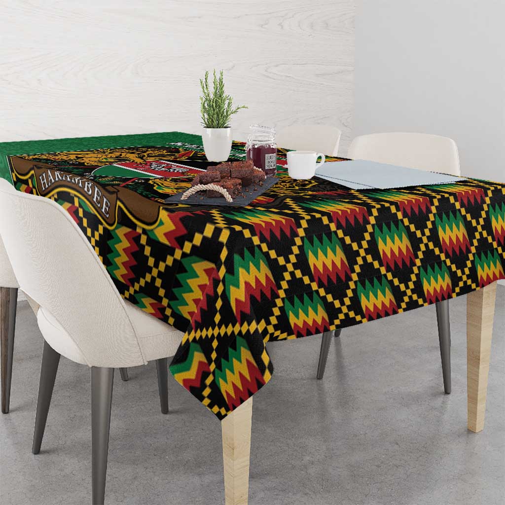 Green kente-pattern tablecloth draped over dining table with zigzag geometric border