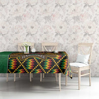 Green kente-pattern tablecloth with coat of arms band, placed on dining table
