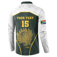 Back of green rugby-style button sweatshirt with YOUR TEXT 15 and protea emblem