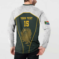 Back of green rugby-style button sweatshirt with YOUR TEXT 15 and protea panel, sleeve flag