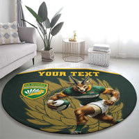 Round green rug with cartoon Springboks mascot, leaf pattern, and “YOUR TEXT”