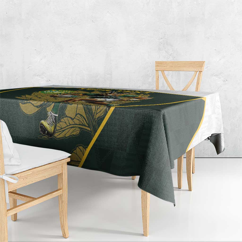 Green tablecloth with yellow border draped over bench table corner