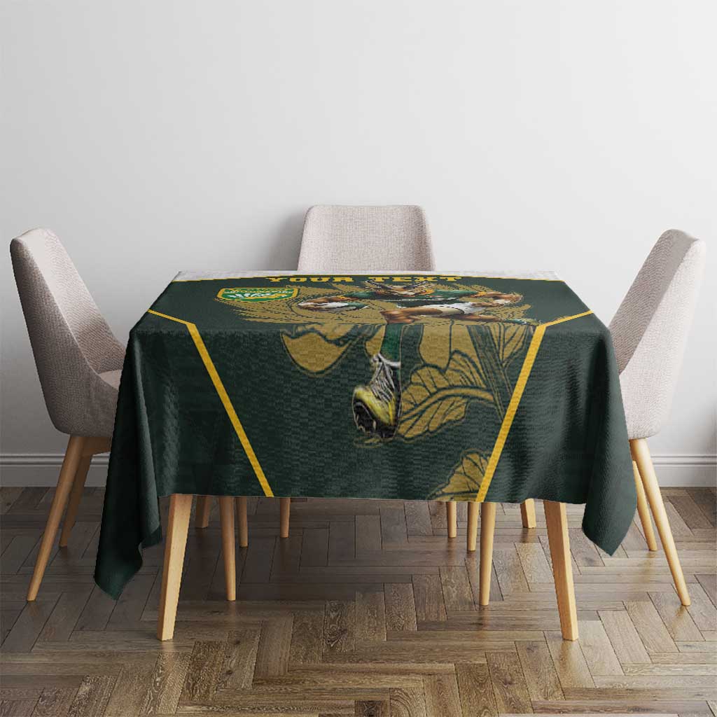Green tablecloth with yellow trim and rugby mascot graphic on small table