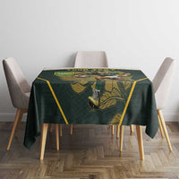 Green tablecloth with yellow trim and rugby mascot graphic on small table