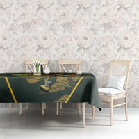 Green tablecloth with yellow border and mascot print across dining table