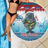 Round beach blanket over swimmer, manatee in Santa hat with glowing lights, Feliz Natal