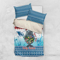 Blue Christmas bedding set laid flat: duvet cover with manatee and sea pattern