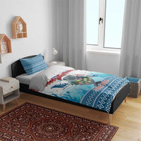 Blue Christmas bedding set on bed: manatee and ocean waves with patterned border