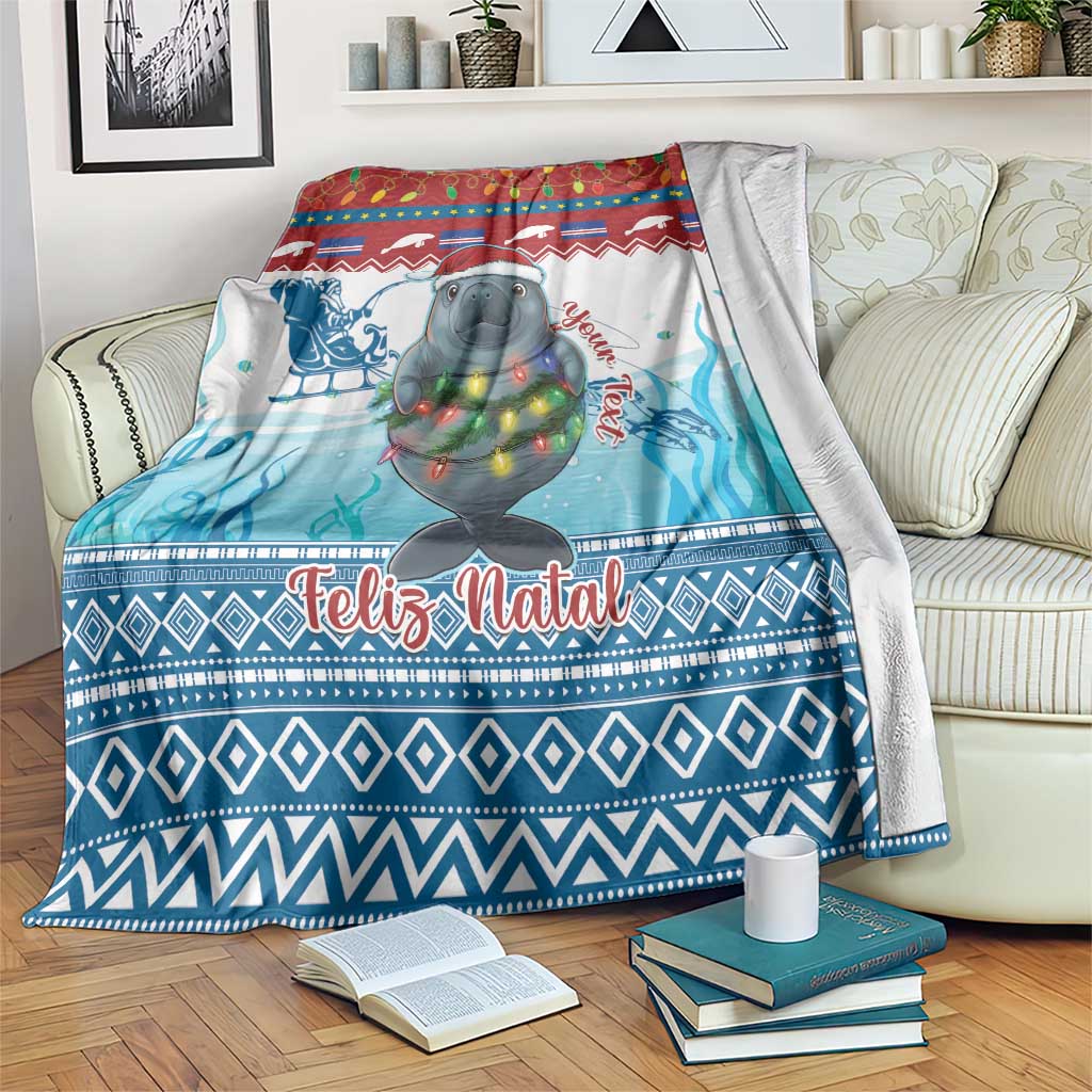 Blue Christmas blanket with manatee, colorful lights, and “Feliz Natal” text on couch