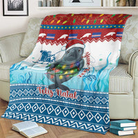 Blue Christmas blanket with manatee wearing a Santa hat, “Feliz Natal” across the center