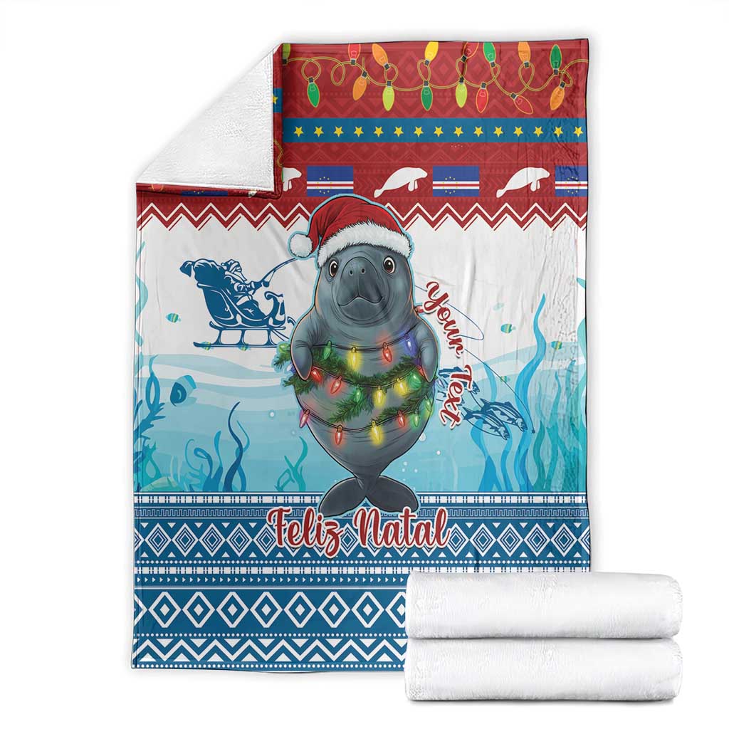 Blue Christmas blanket with manatee, festive lights, “Feliz Natal” text, folded with towels