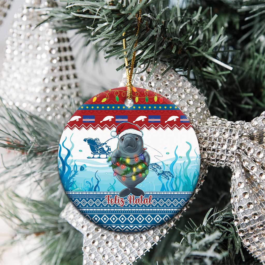 Blue ceramic round ornament with manatee holding glowing lights, “Feliz Natal” text, hanging