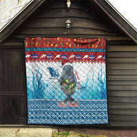 Blue Christmas quilt with manatee, Feliz Natal text, and red-white top band hanging on a wall