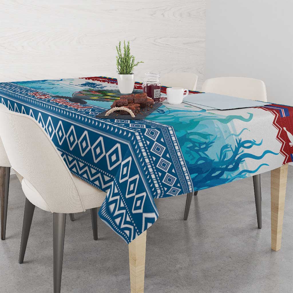 Blue manatee Christmas tablecloth with geometric border, overhanging table corners