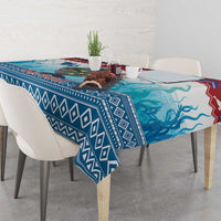 Blue manatee Christmas tablecloth with geometric border, overhanging table corners