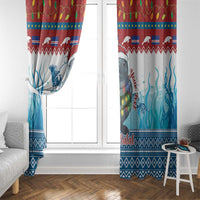 Blue manatee 'Feliz Natal' window curtains framing a window, patterned bottom border