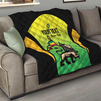 Quilted black quilt with yellow-green Jamaican jersey graphic and custom text on sofa